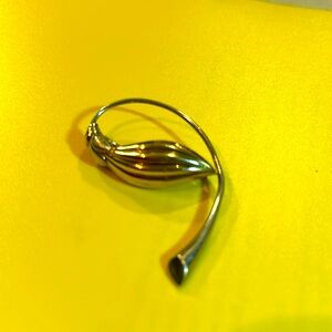 Silver with gold tint, handmade brooch stamped S 925 The weight is .14 g.